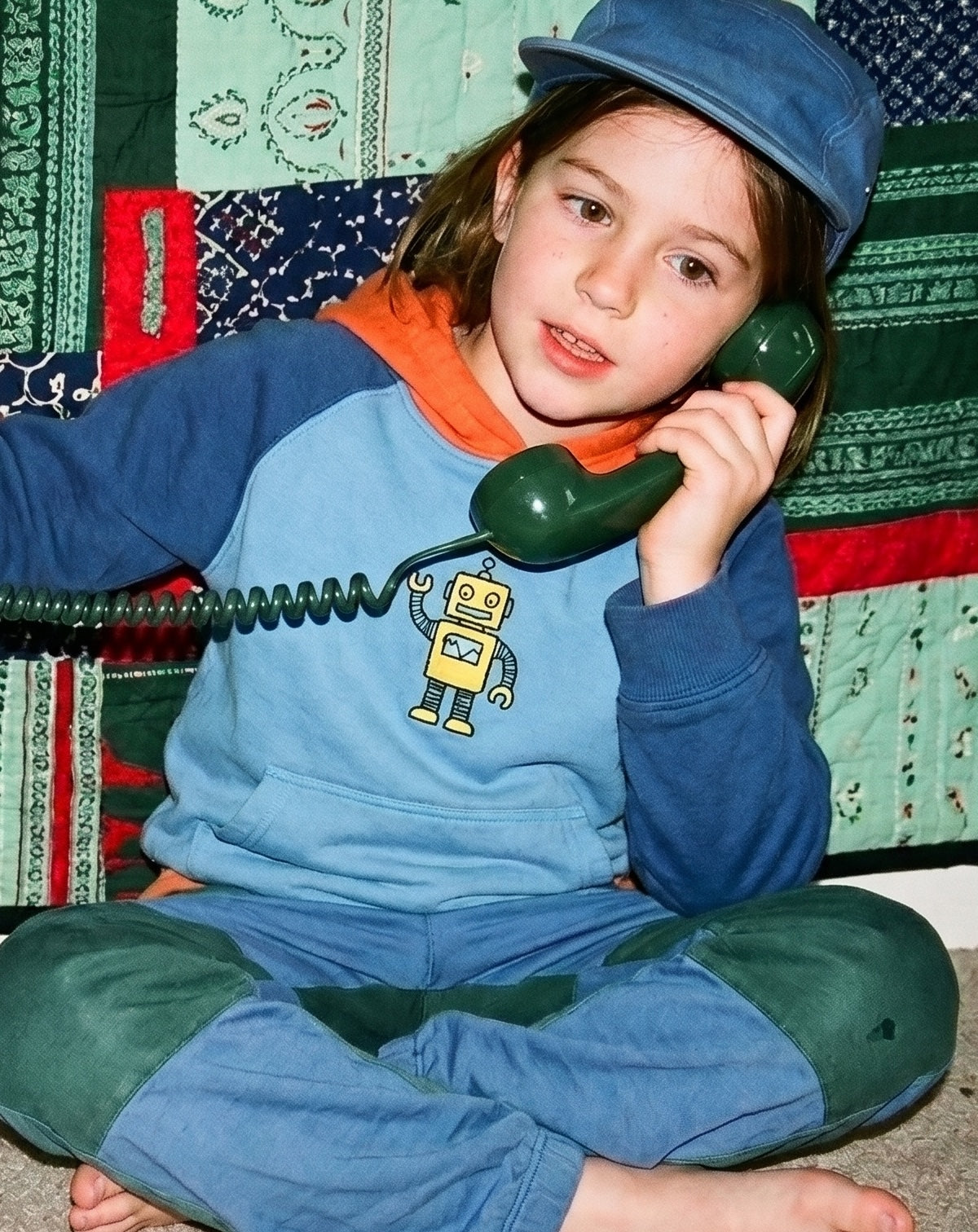 Enfant avec un téléphone combiné bleu vert 